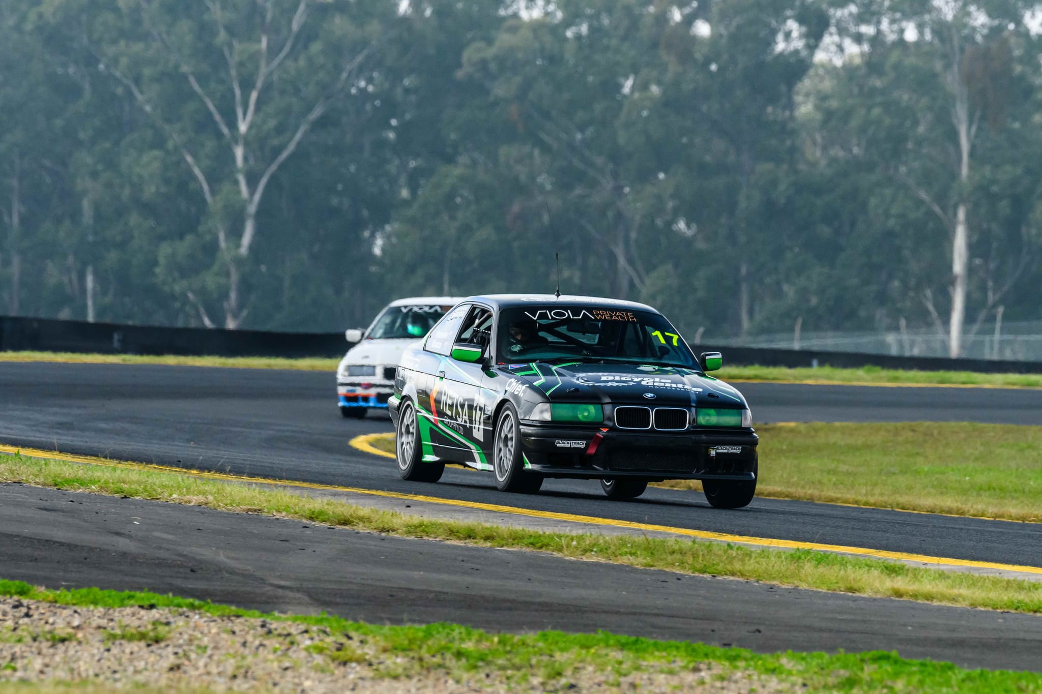 The #17 Project E36 leading another car through a corner during the Sydney 300