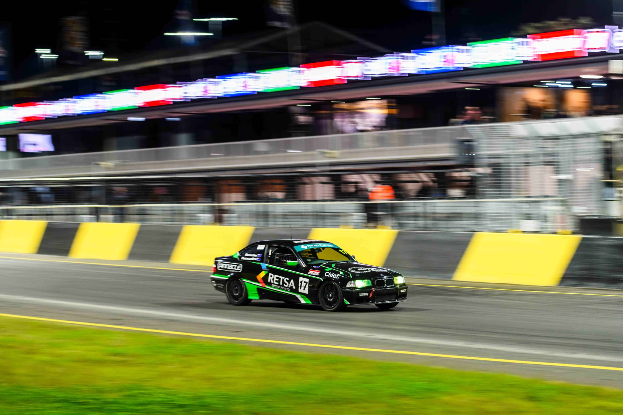 Project E36 Racing Car racing at night under track lights